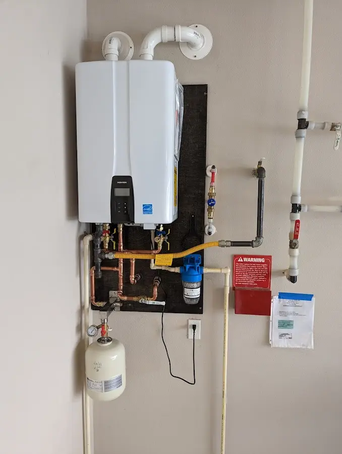 Professional plumber installing copper piping in a Wright home